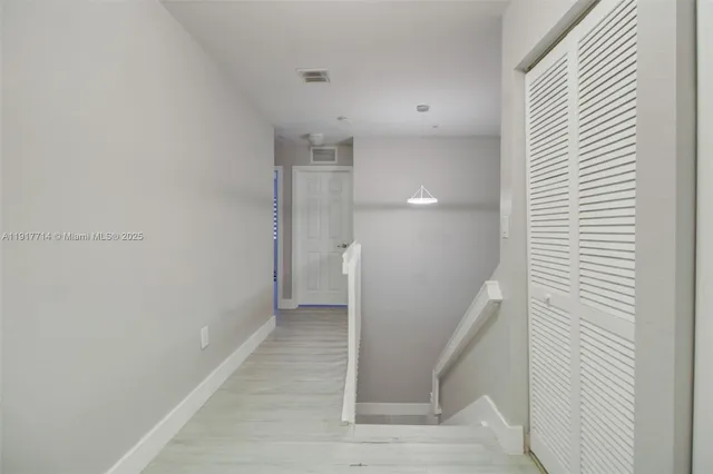 a view of a hallway with staircase