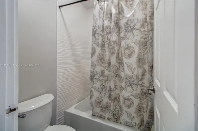 a bathroom with a toilet and shower