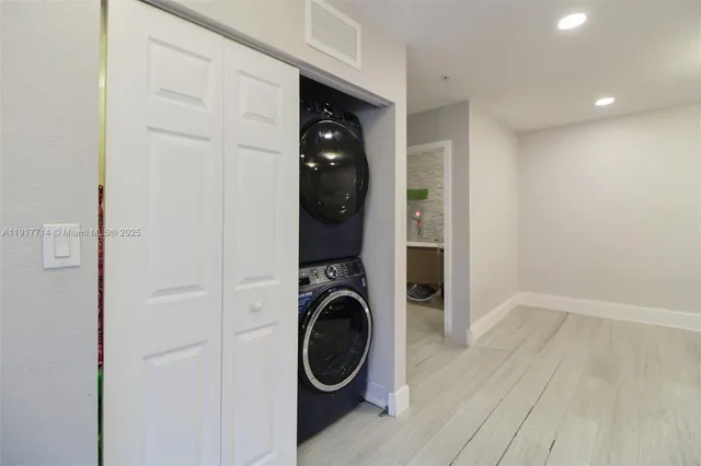 a view of a hallway with washer and dryer