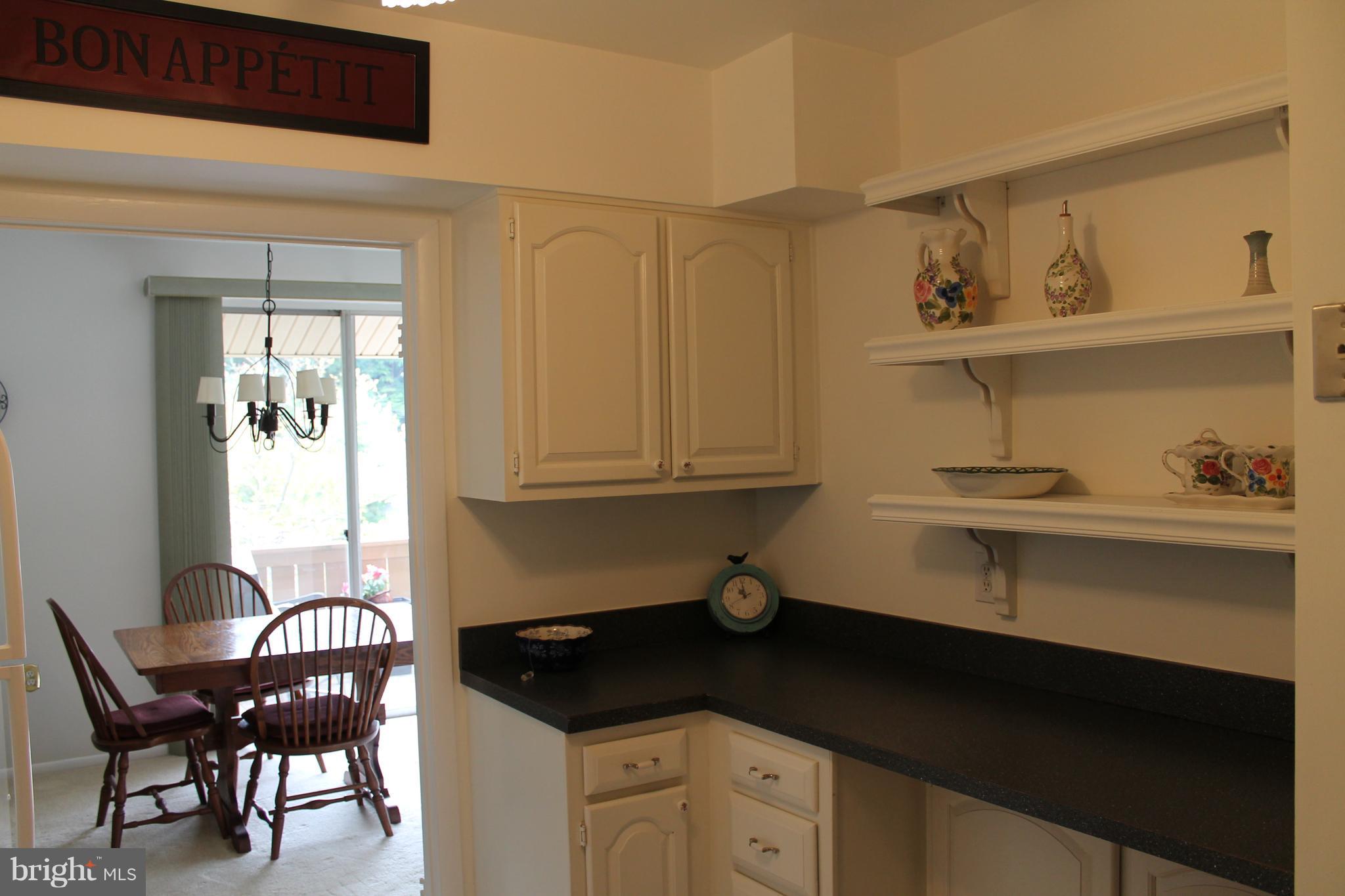23 Hamill Road, Unit 23F Baltimore, MD 21210 - Photo 3 of 11 a kitchen with a sink cabinets and wooden floor