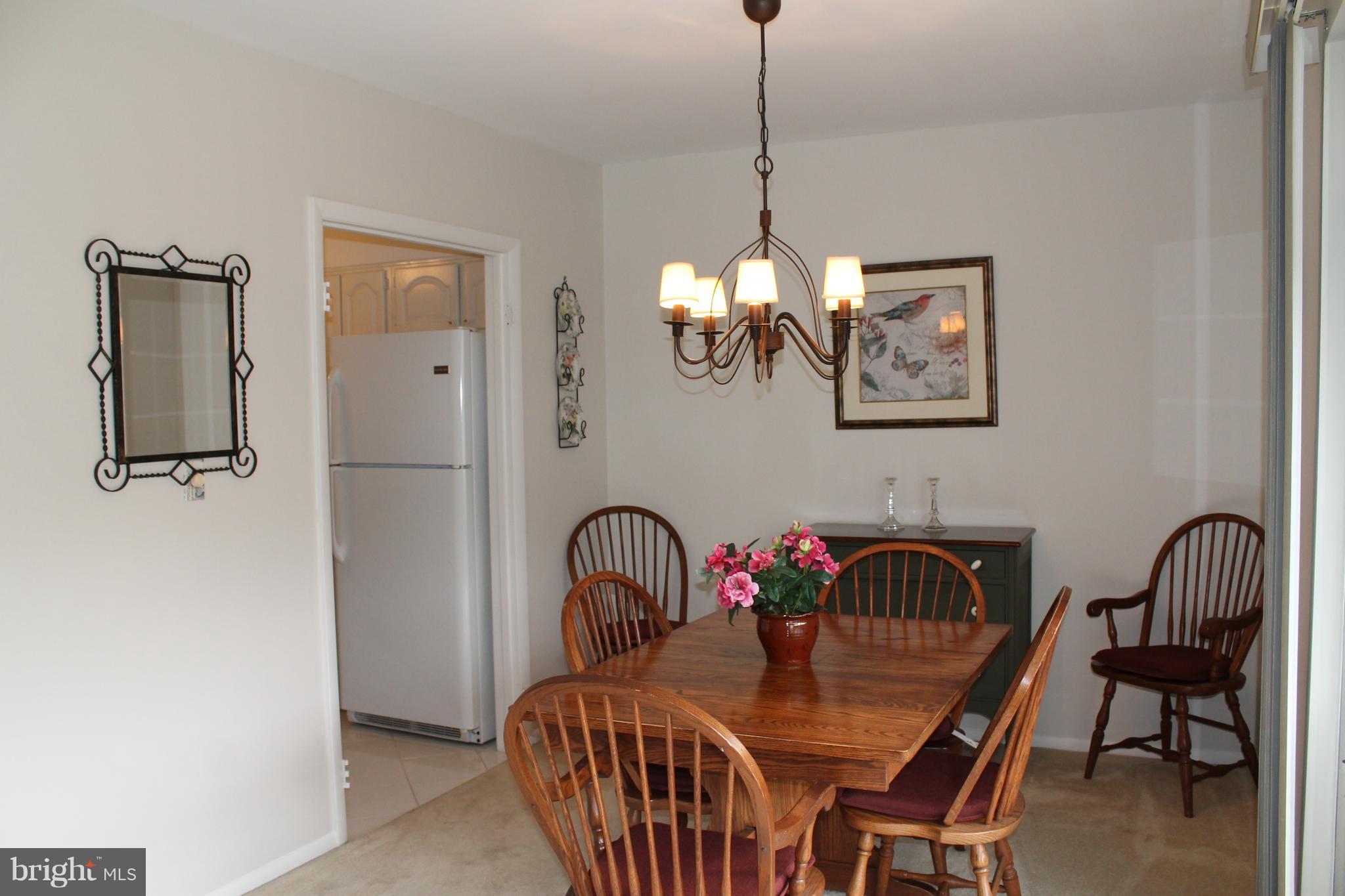 23 Hamill Road, Unit 23F Baltimore, MD 21210 - Photo 5 of 11 a view of a dining room with furniture and chandelier
