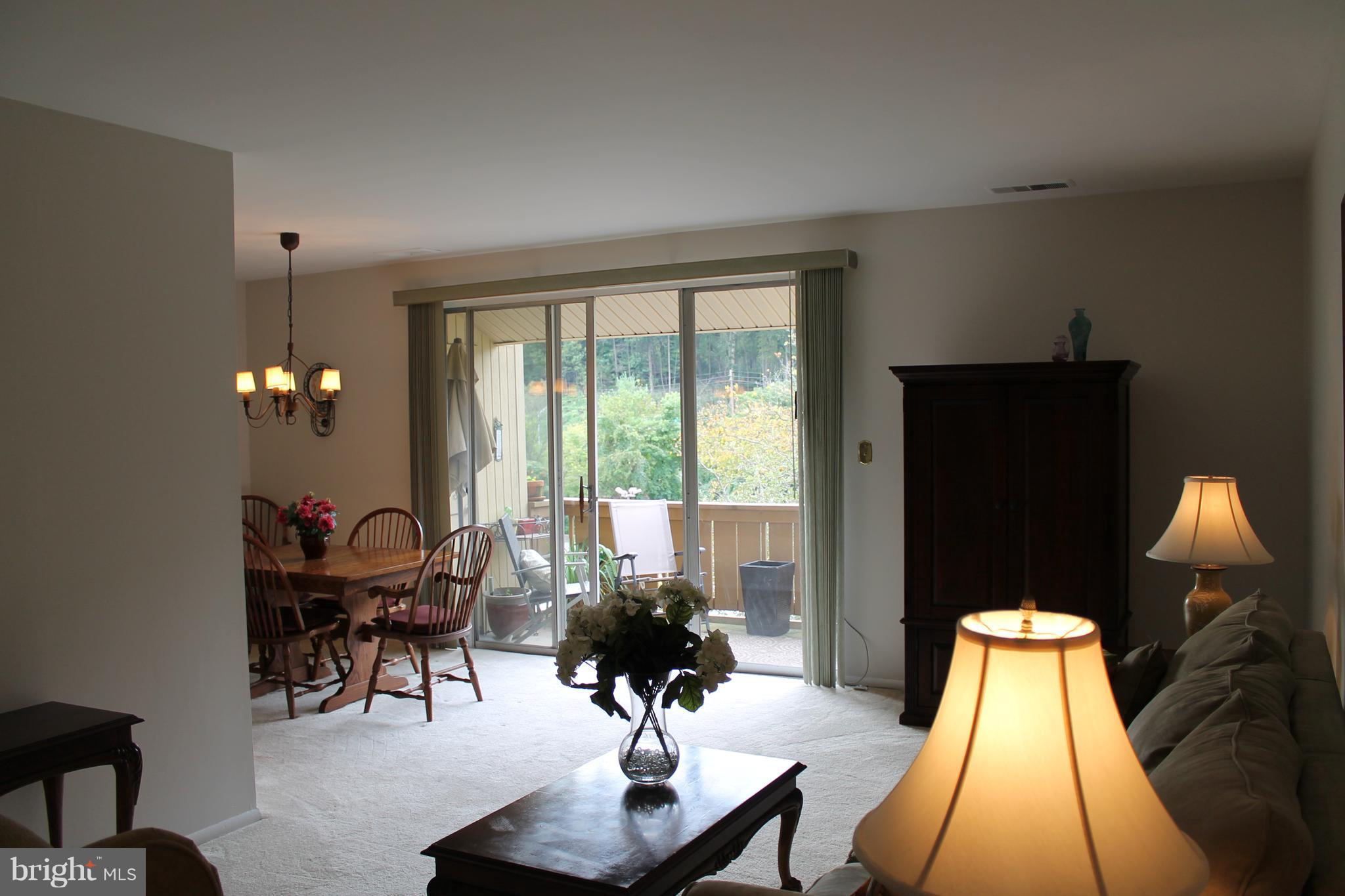 23 Hamill Road, Unit 23F Baltimore, MD 21210 - Photo 8 of 11 a living room with furniture and a large window