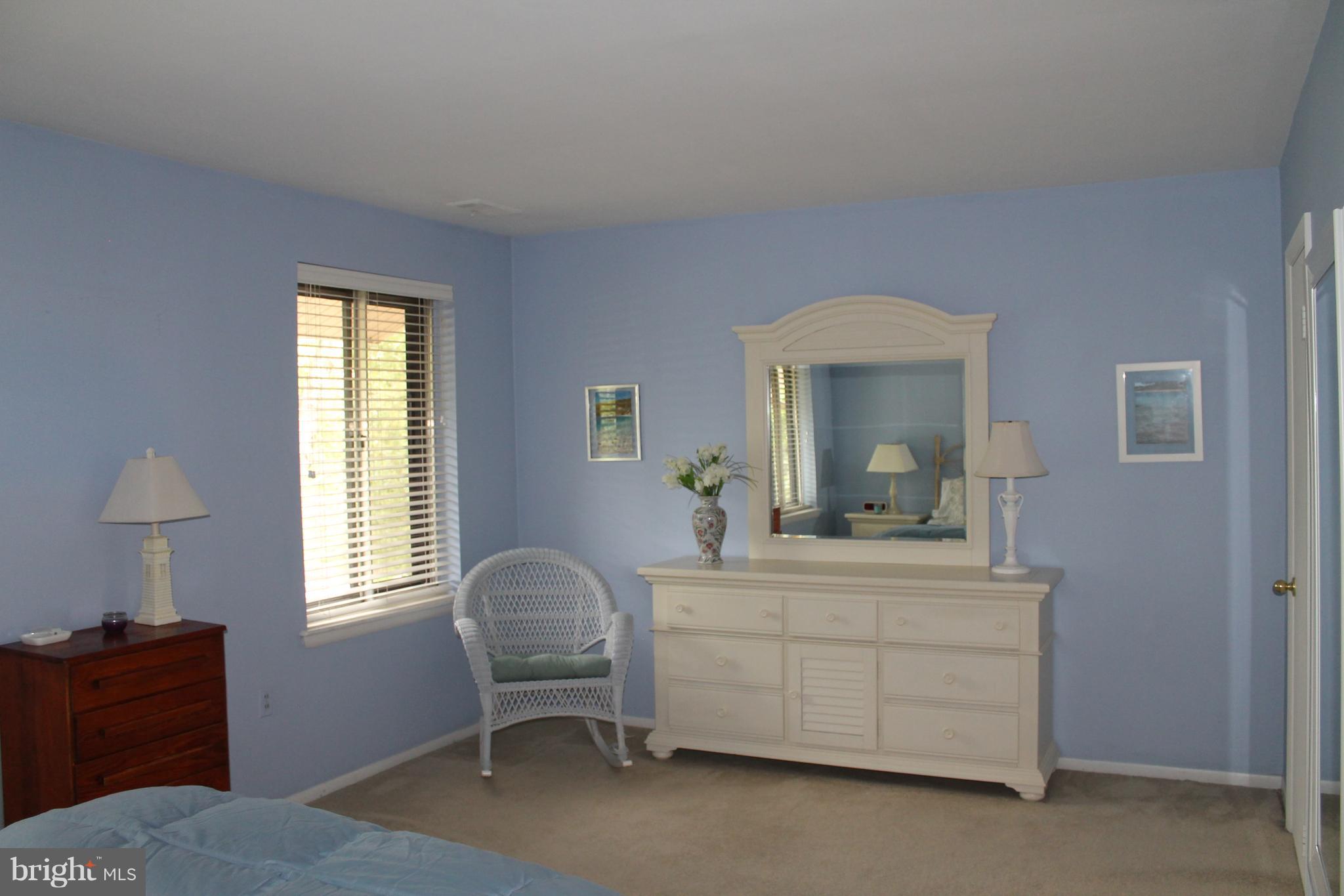 23 Hamill Road, Unit 23F Baltimore, MD 21210 - Photo 10 of 11 a bedroom with a bed and a dresser next to a window