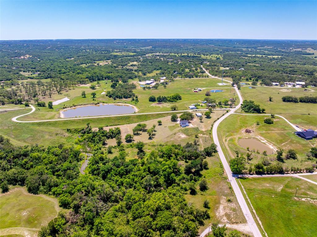 1874 County Road Springtown, TX 76082 - Photo 20 of 24 an aerial view of residential houses with outdoor space and swimming pool