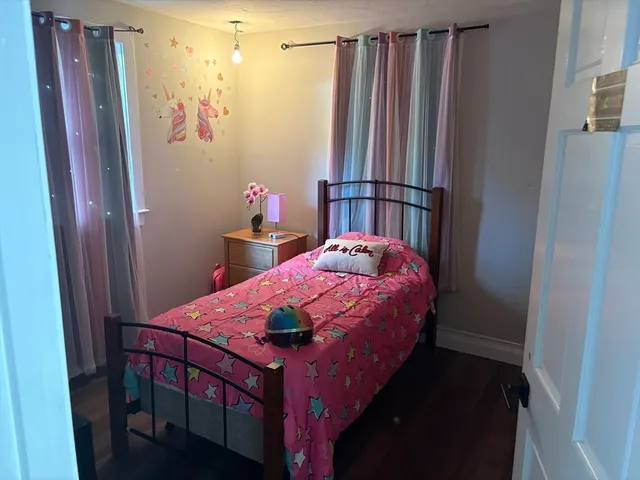 a bedroom with a bed and a mirror