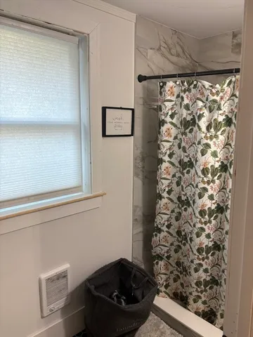 a room with a black white wall and a shower curtain