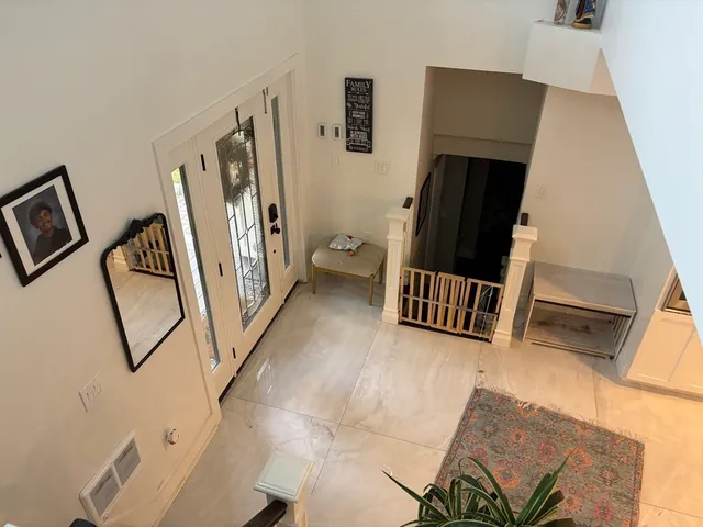 a view of entryway with furniture and wooden floor