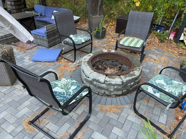 a view of a chairs and tables in the back yard of the house