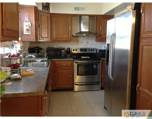 462 A Delair Road Monroe Township, NJ 08831 - Photo 2 of 10 a kitchen with a refrigerator and a sink