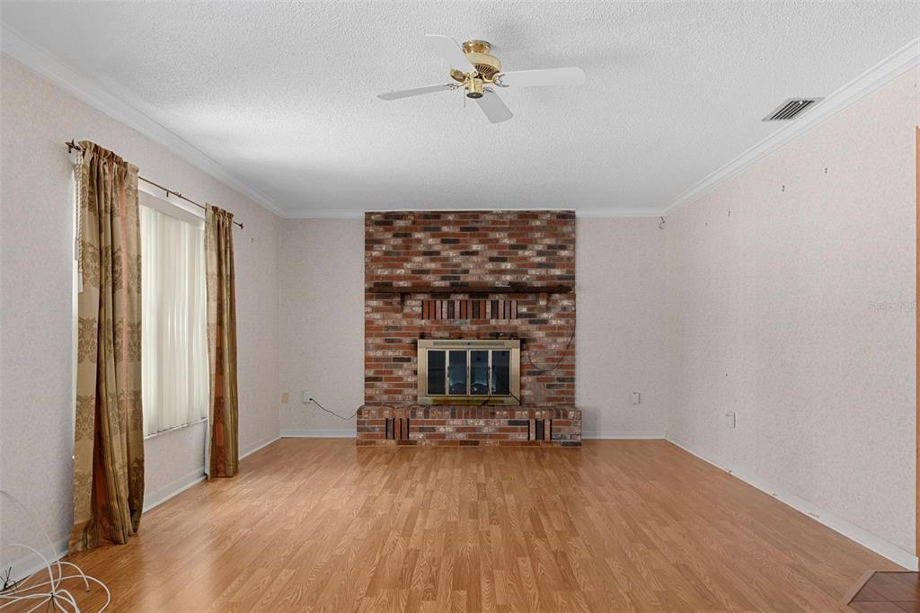 649 Southwest Bend Point Lecanto, FL 34461 - Photo 21 of 50 wooden floor in an empty room with a fireplace
