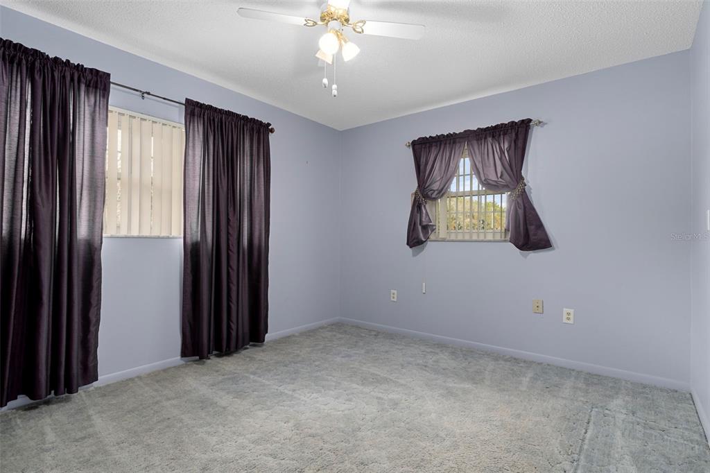 649 Southwest Bend Point Lecanto, FL 34461 - Photo 25 of 50 an empty room that has a window and a chandelier fan