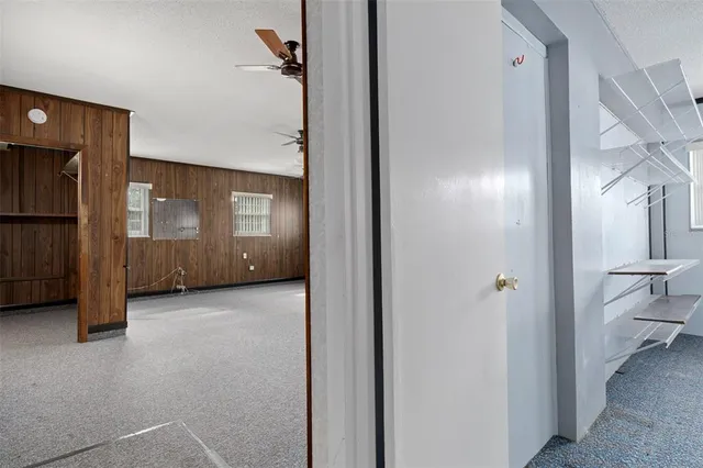 a view of an empty room with a ceiling fan
