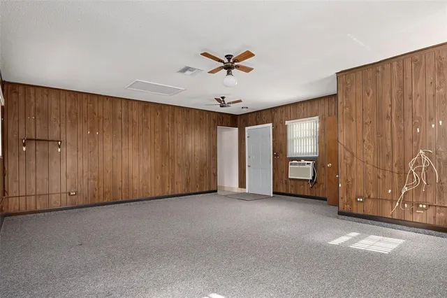a backyard of a house with a yard and outdoor seating
