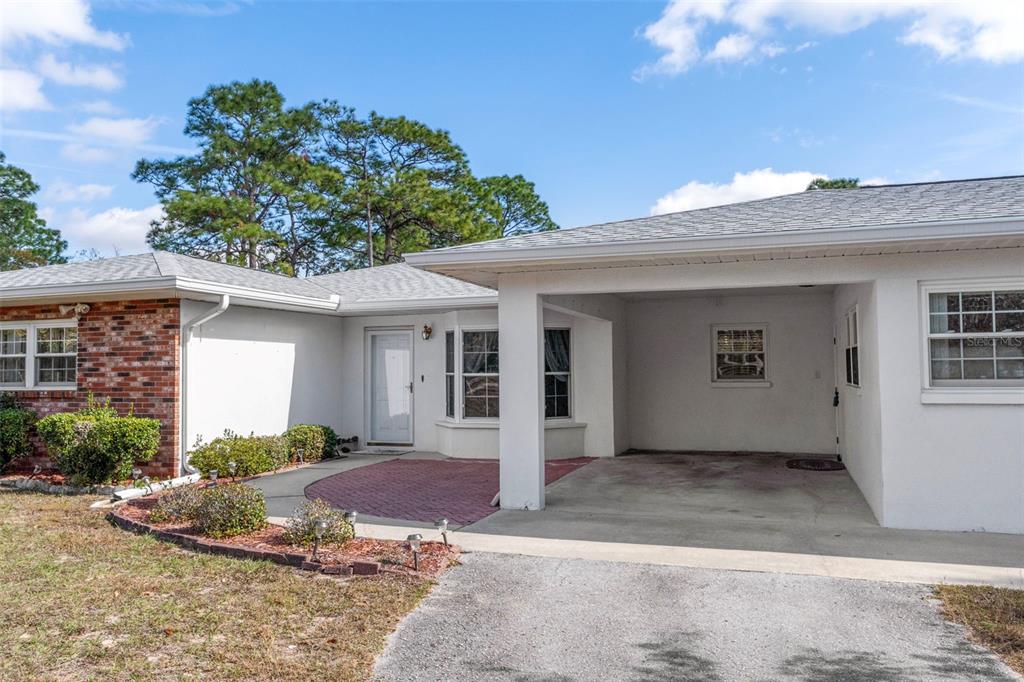 649 Southwest Bend Point Lecanto, FL 34461 - Photo 10 of 50 a front view of a house with a yard and potted plants