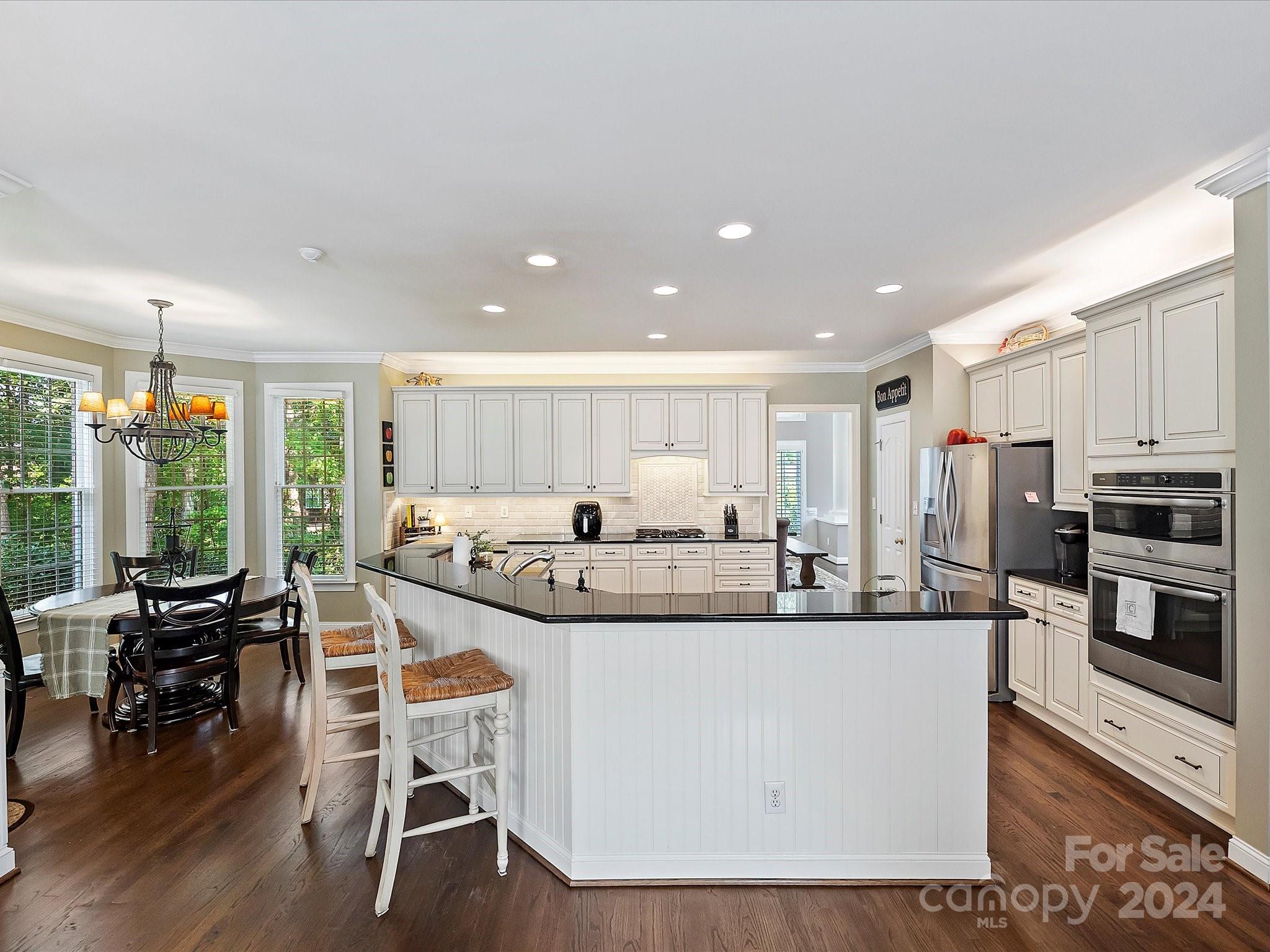 10309 Riesling Court Charlotte, NC 28277 - Photo 16 of 44 a large kitchen with stainless steel appliances kitchen island granite countertop a large island in the center