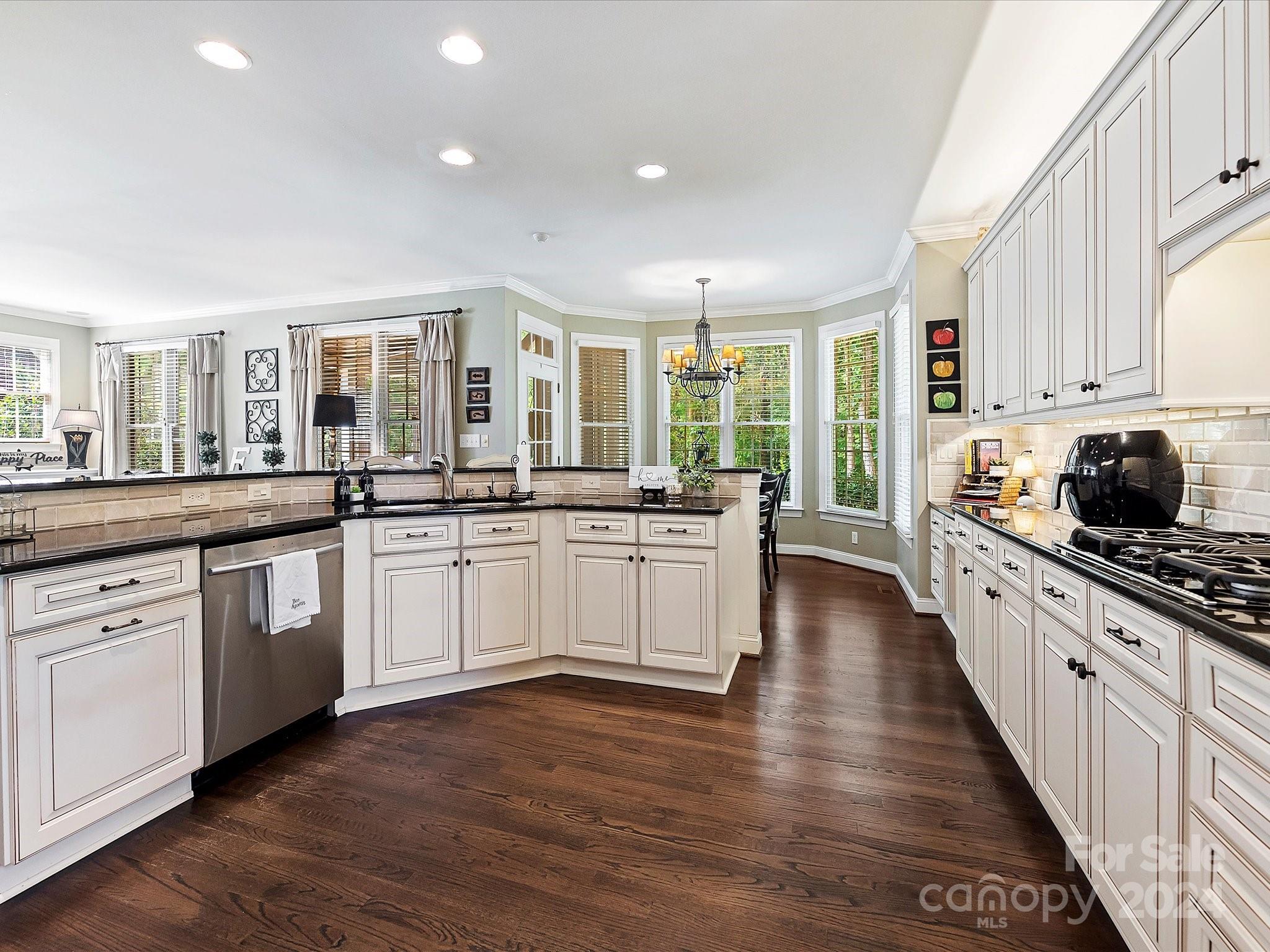 10309 Riesling Court Charlotte, NC 28277 - Photo 18 of 44 a large kitchen with stainless steel appliances a large window and white cabinets