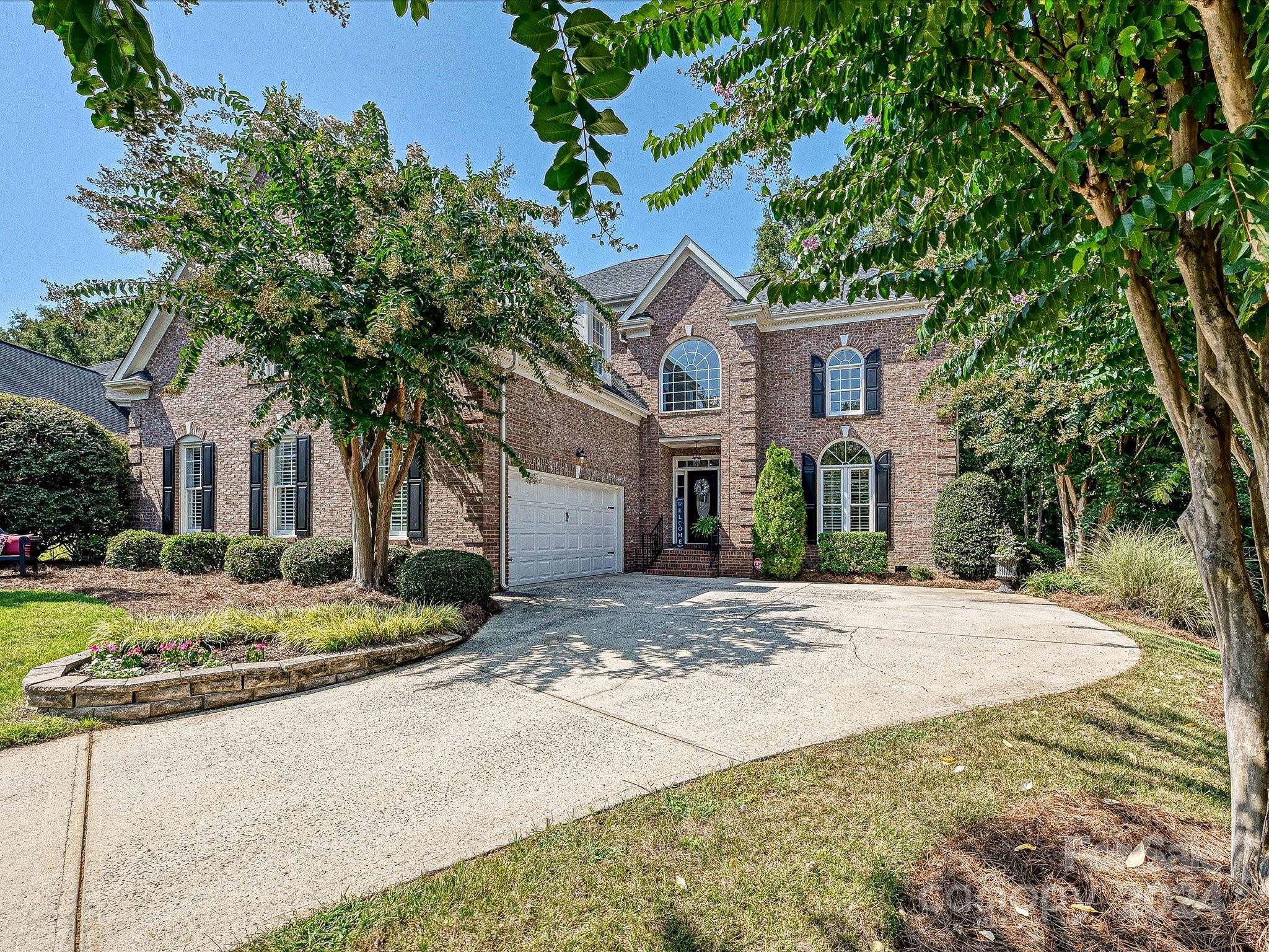 10309 Riesling Court Charlotte, NC 28277 - Photo 2 of 44 a front view of a house with a yard and garage