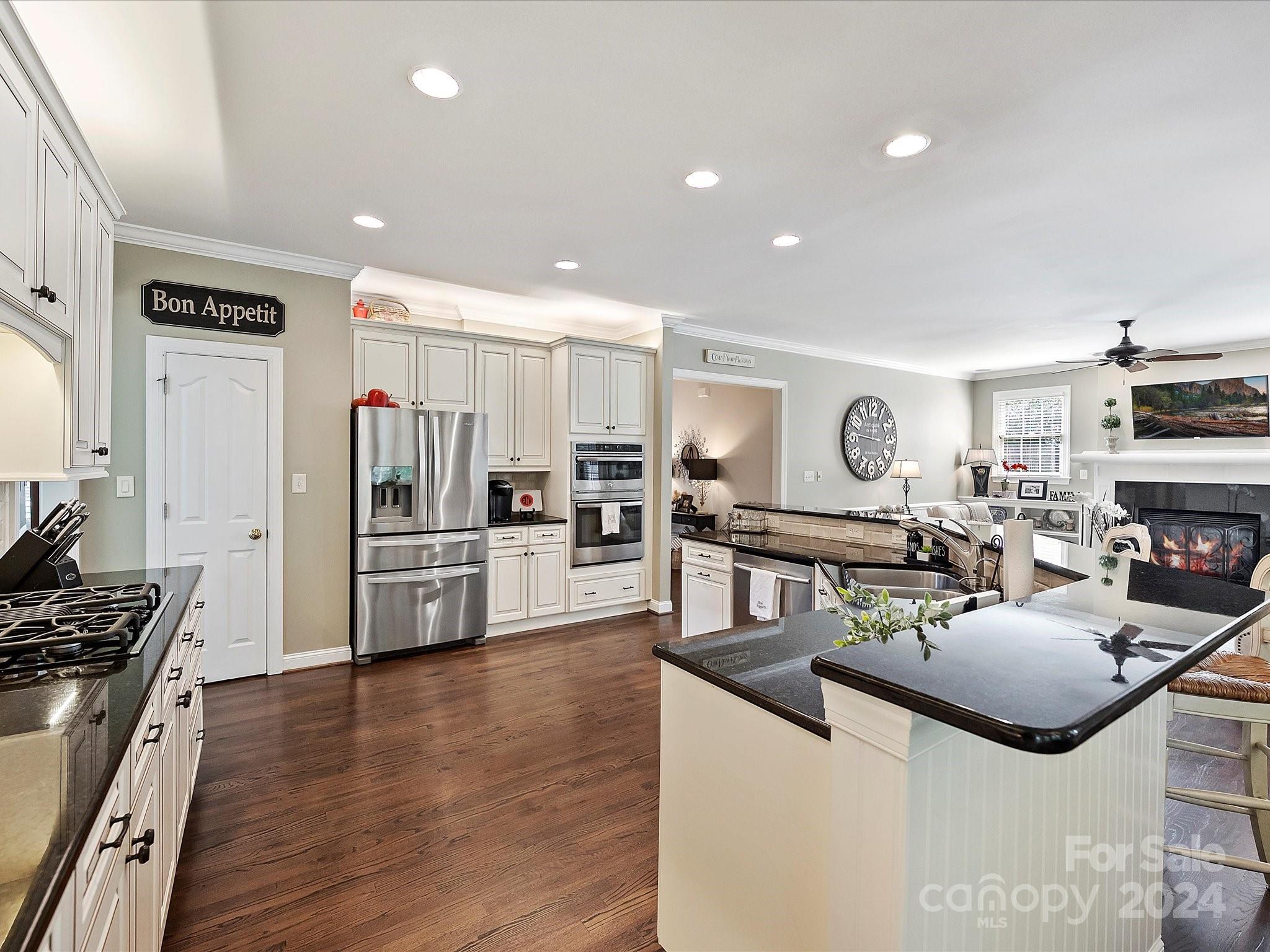 10309 Riesling Court Charlotte, NC 28277 - Photo 21 of 44 a kitchen with stainless steel appliances kitchen island granite countertop a stove and a refrigerator