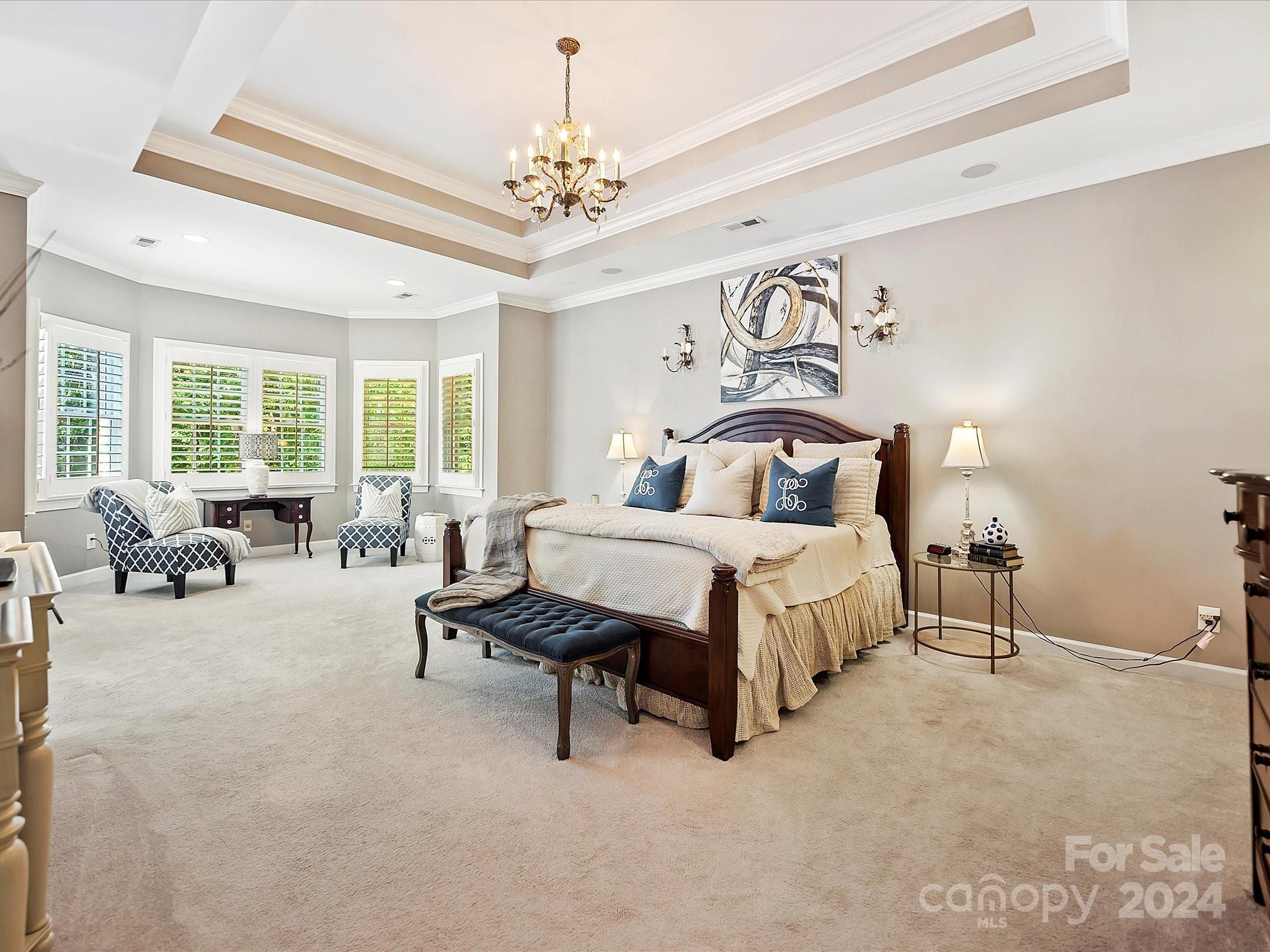10309 Riesling Court Charlotte, NC 28277 - Photo 27 of 44 a bedroom with bed and a chandelier