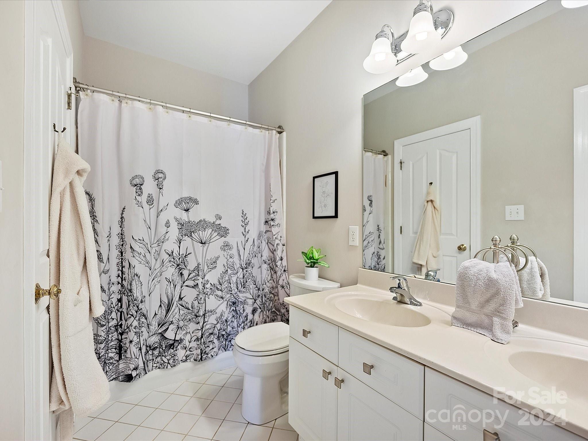 10309 Riesling Court Charlotte, NC 28277 - Photo 35 of 44 a bathroom with a granite countertop sink a toilet and a large mirror