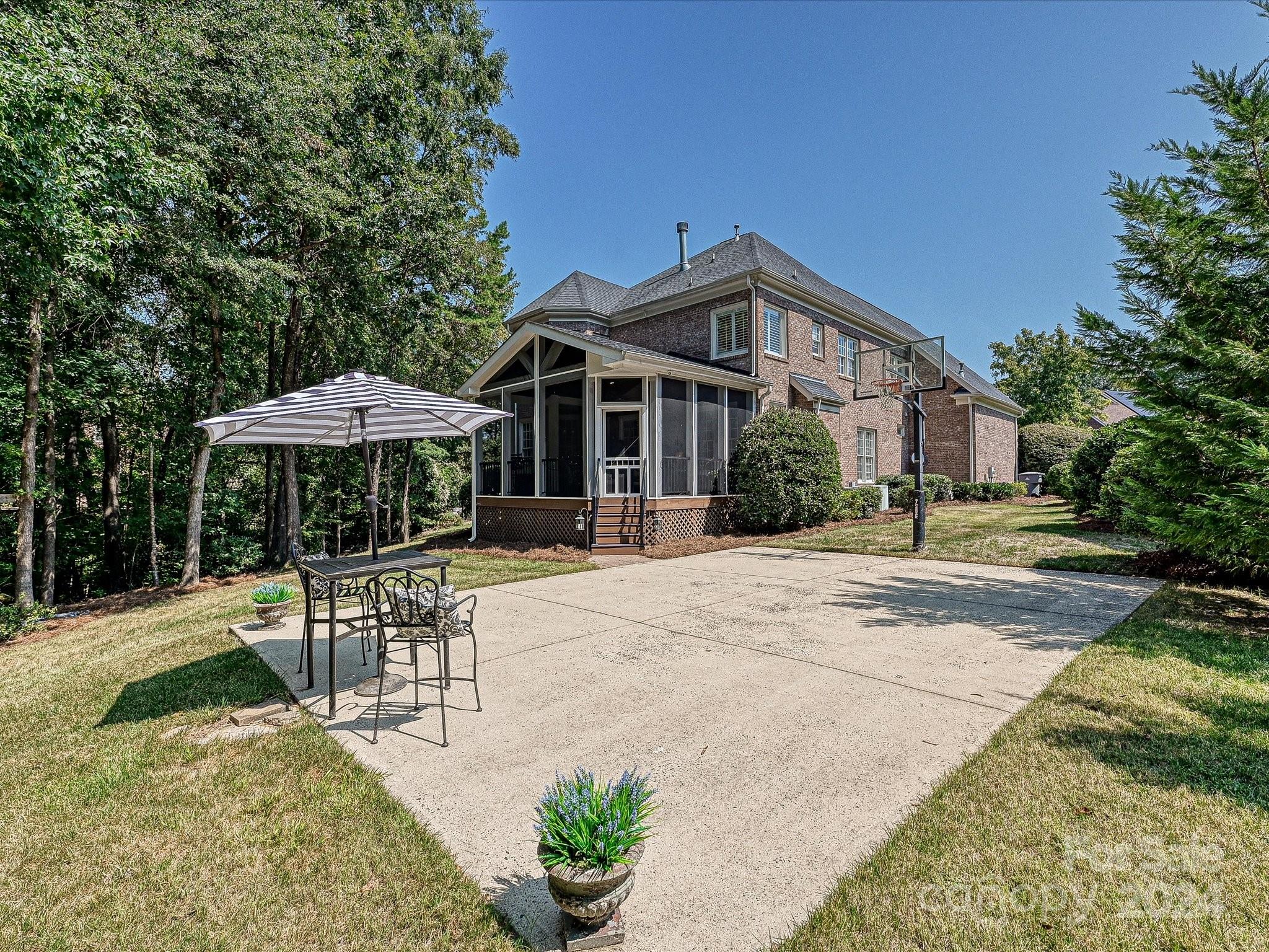 10309 Riesling Court Charlotte, NC 28277 - Photo 43 of 44 a patio with a table and chairs under an umbrella