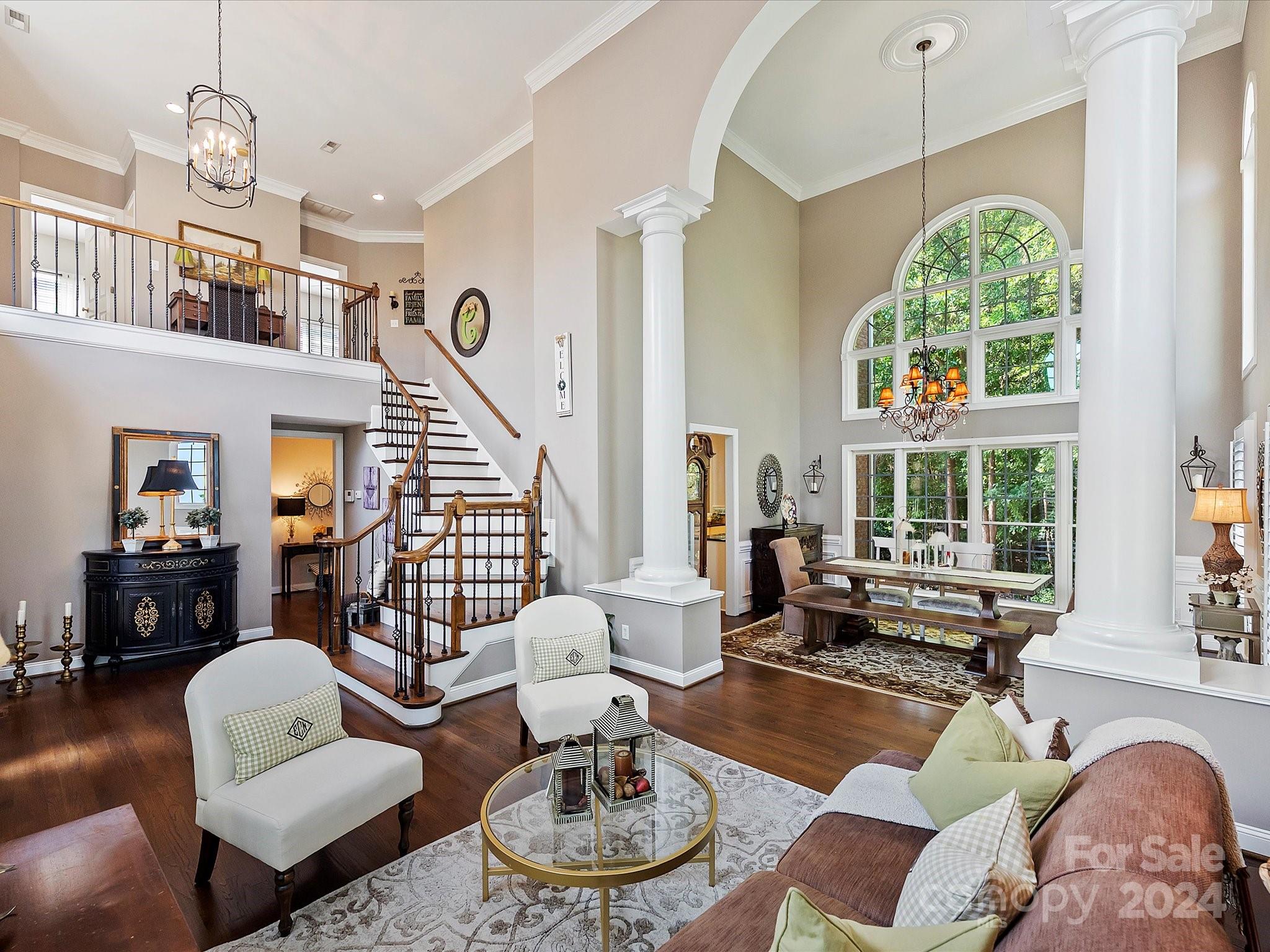 10309 Riesling Court Charlotte, NC 28277 - Photo 7 of 44 a living room with furniture chandelier and a large window