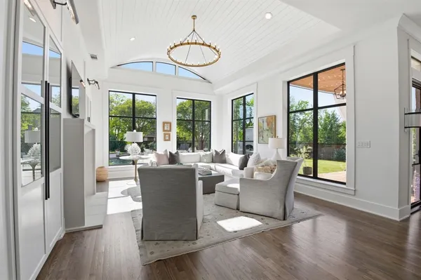 a view of a dining room with furniture wooden floor and chandelier