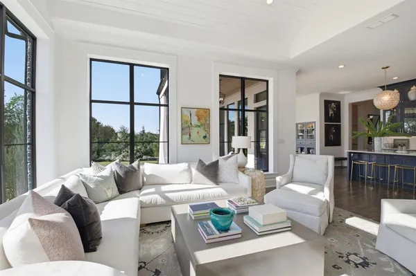 a living room with furniture and large windows