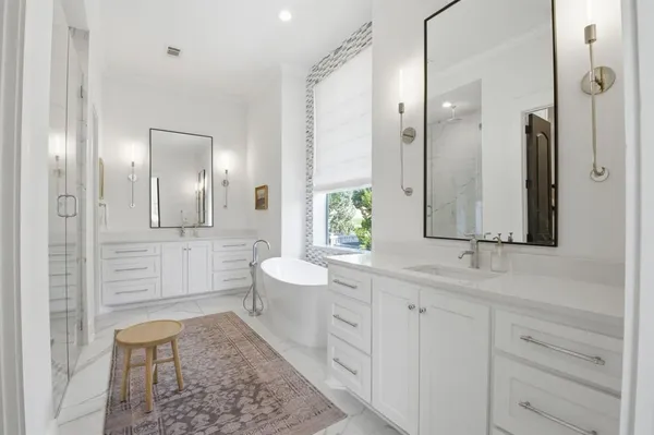 a bathroom with a sink a toilet and a large mirror
