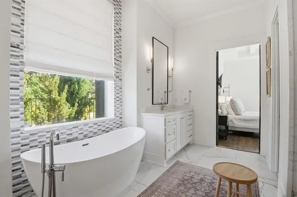 a en suite bathroom with a granite countertop toilet sink and mirror