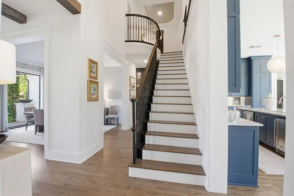 a view of entryway and hall with wooden floor