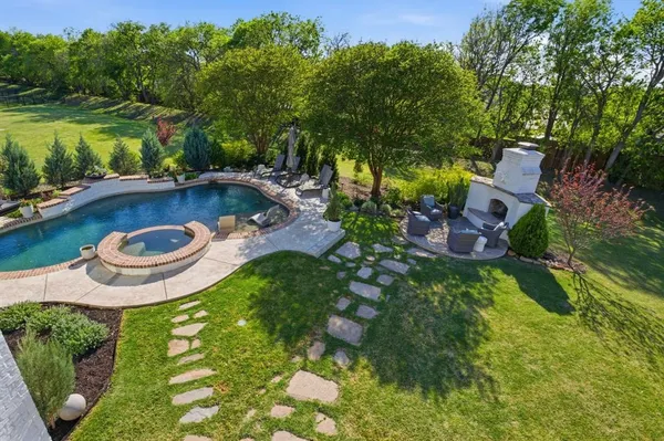 a view of a swimming pool with a yard