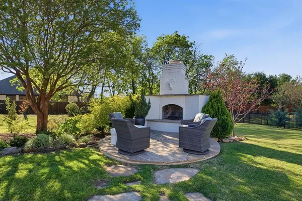 a view of a house with backyard sitting area and garden