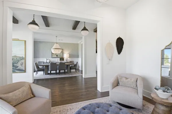 a living room with furniture and a floor to ceiling window