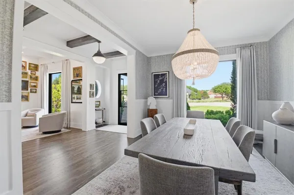 a view of a dining room with furniture wooden floor and chandelier