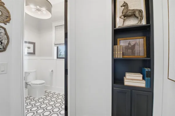 a bathroom with a toilet a sink and mirror
