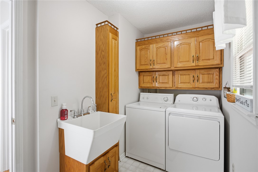 110 Snug Harbor Road Seneca, SC 29678 - Photo 14 of 37 This dedicated utility room offers convenient functionality with ample storage and laundry appliances.