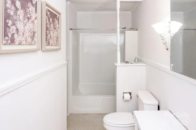 a white toilet sitting next to a bathroom sink
