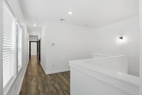 a view of a room with wooden floor