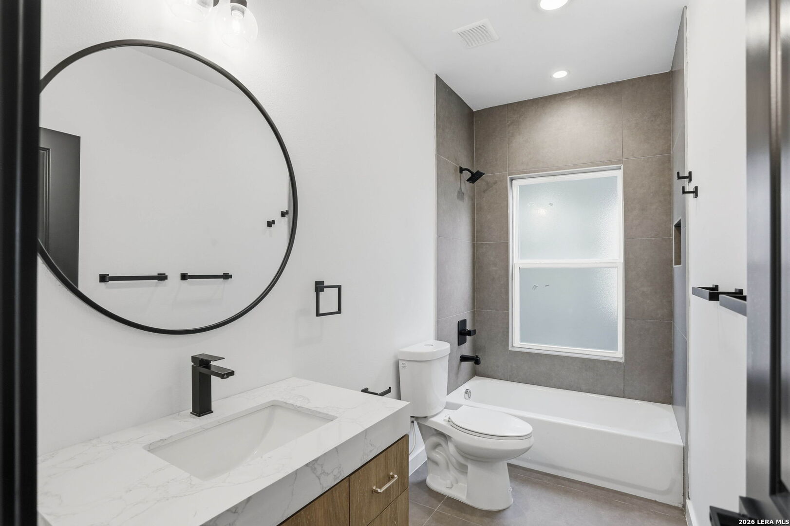 317 Porter Street San Antonio, TX 78210 - Photo 21 of 40 a bathroom with a sink a toilet and a mirror