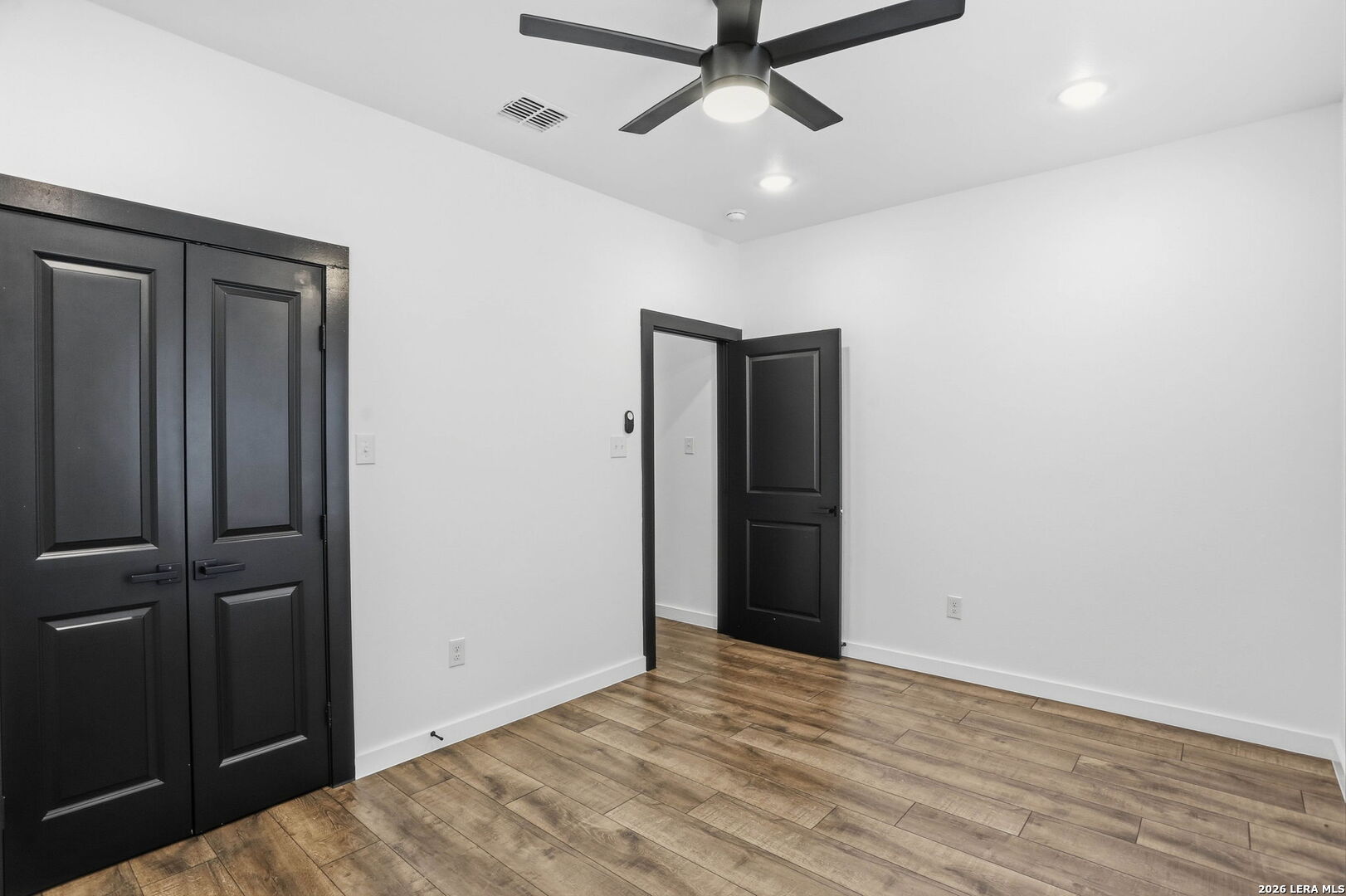 317 Porter Street San Antonio, TX 78210 - Photo 23 of 40 an empty room with wooden floor closet and windows