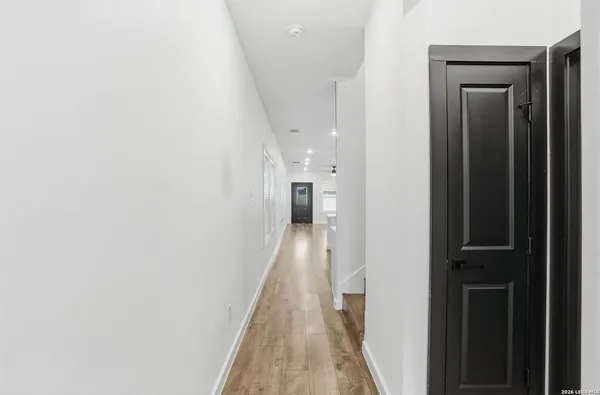a view of hallway with wooden floor