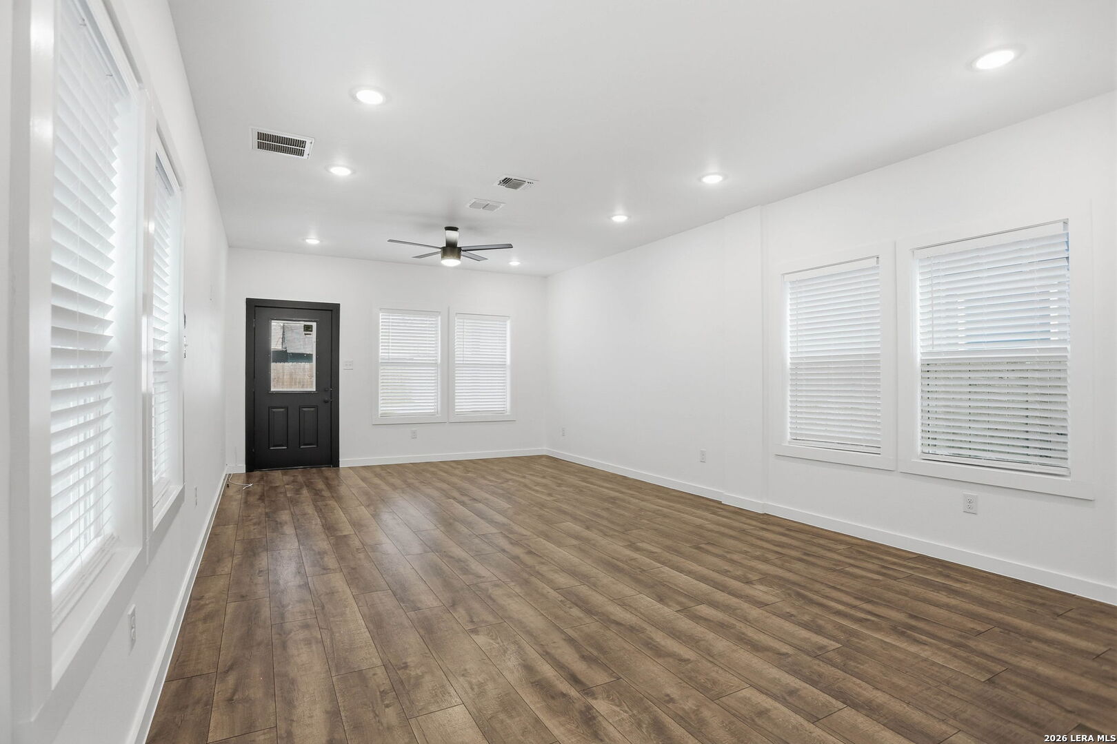 317 Porter Street San Antonio, TX 78210 - Photo 5 of 40 a view of an empty room with wooden floor and a window