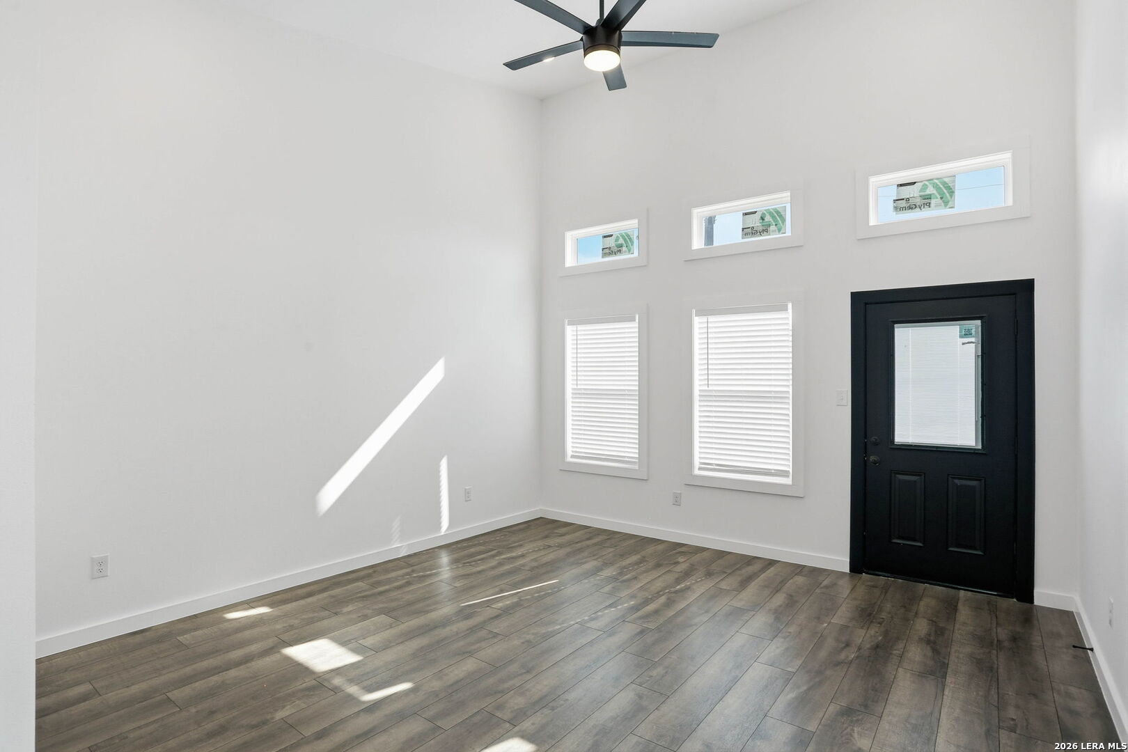 317 Porter Street San Antonio, TX 78210 - Photo 6 of 40 an empty room with wooden floor cabinet and windows