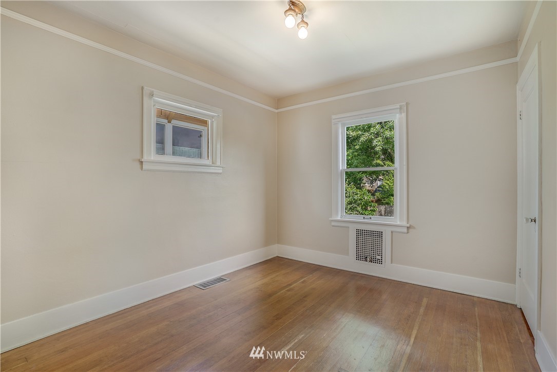 548 North 68th Street Seattle, WA 98103 - Photo 10 of 20 an empty room with wooden floor and windows