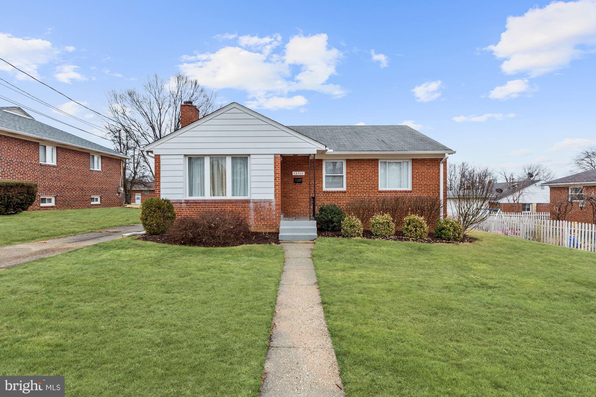 12503 Feldon Street Silver Spring, MD 20906 - Photo 1 of 18 a front view of a house with yard