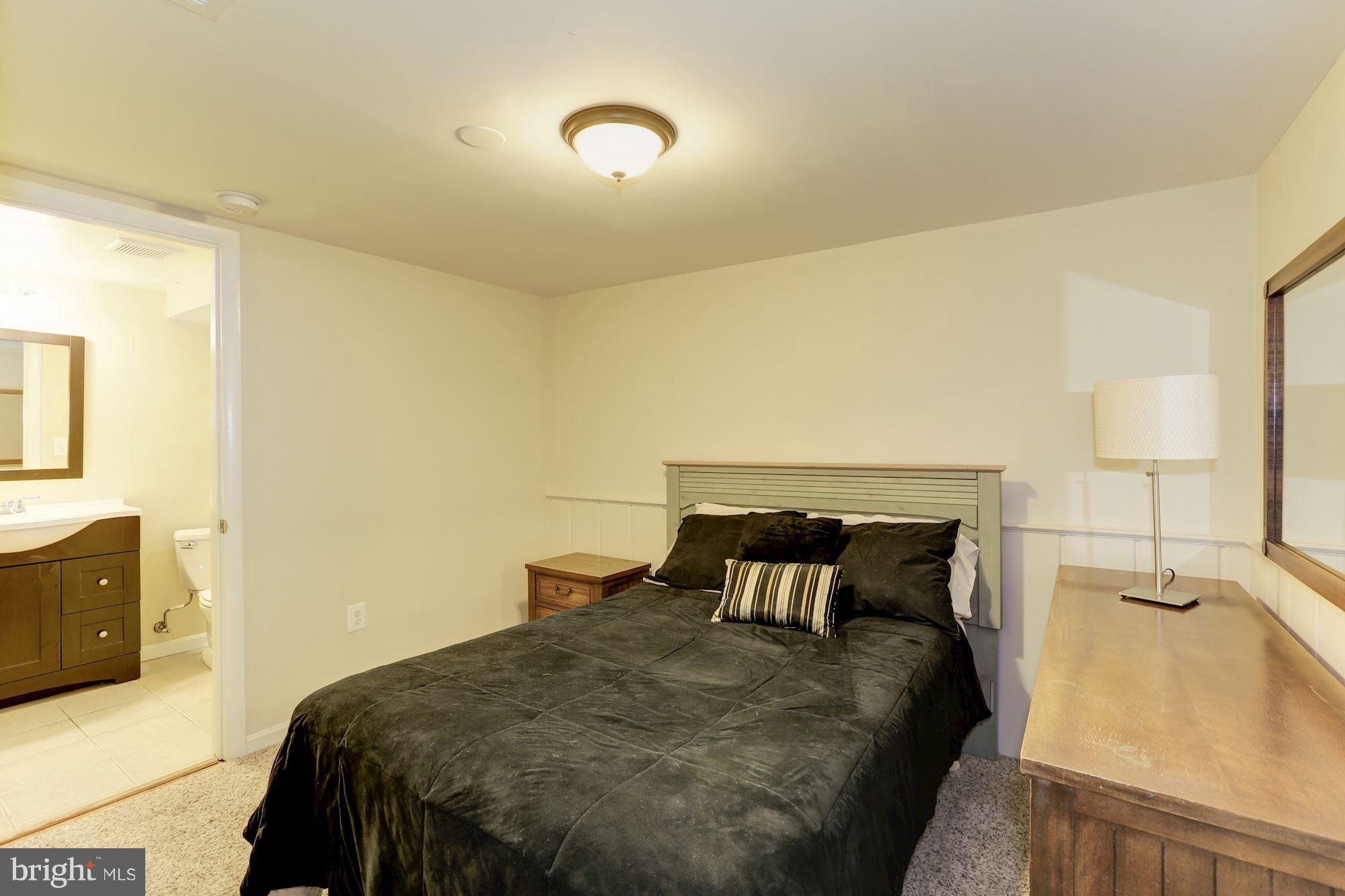 12503 Feldon Street Silver Spring, MD 20906 - Photo 15 of 18 a bedroom with a bed and lamps
