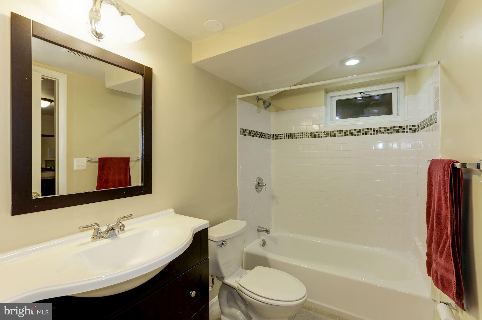 12503 Feldon Street Silver Spring, MD 20906 - Photo 16 of 18 a bathroom with a sink a toilet and shower
