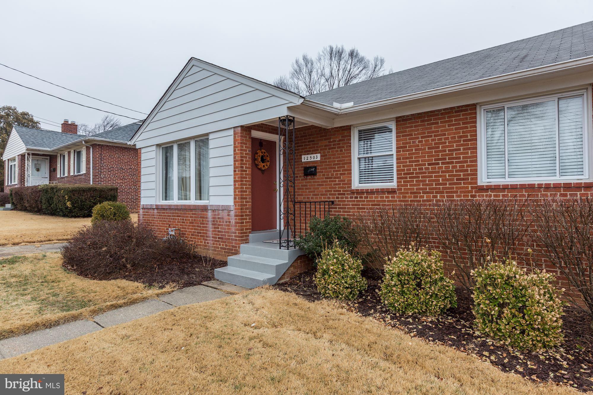 12503 Feldon Street Silver Spring, MD 20906 - Photo 3 of 18 a front view of a house with garden