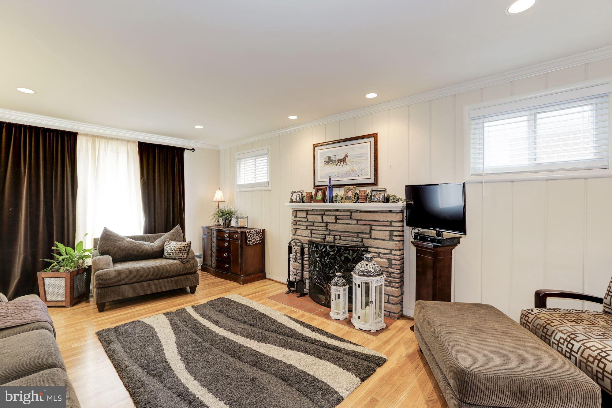 12503 Feldon Street Silver Spring, MD 20906 - Photo 4 of 18 a living room with furniture and a flat screen tv